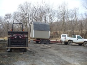 shed being pulled on a trailer 